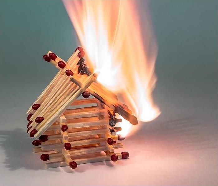 house built from matches with flame